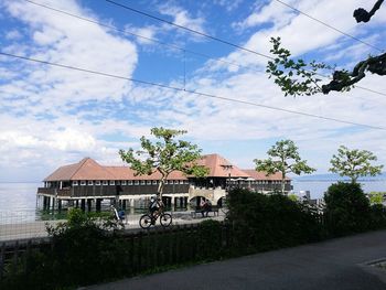 Road by building against sky in city