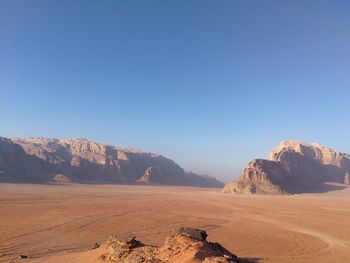 Scenic view of mountains against clear blue sky