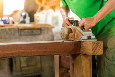 Close-up of man working on wood