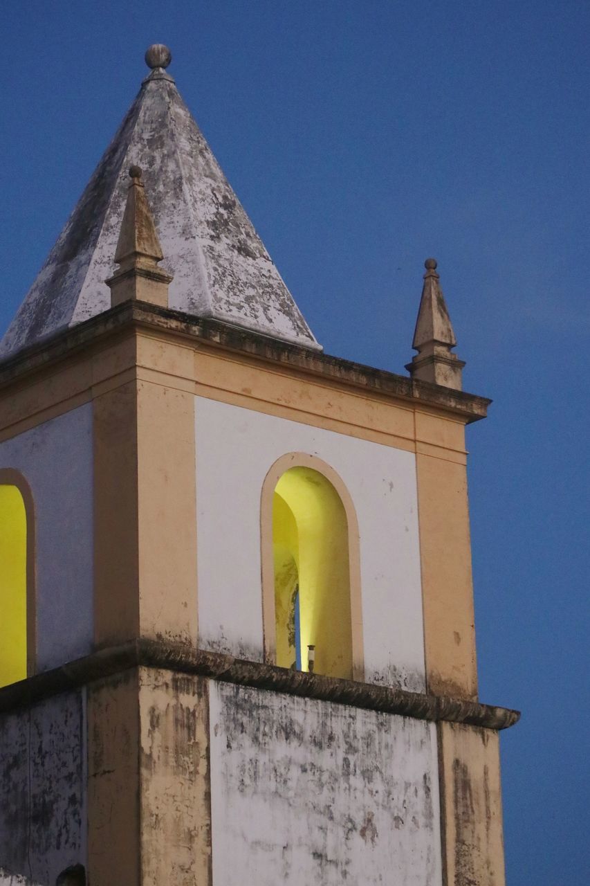 architecture, built structure, building exterior, place of worship, bell tower, religion, sky, building, tower, history, belief, the past, landmark, no people, clear sky, steeple, travel destinations, nature, blue, spirituality, low angle view, day, church bell, outdoors, travel, facade