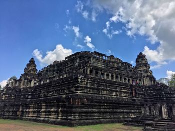 Low angle view of temple against cloudy sky