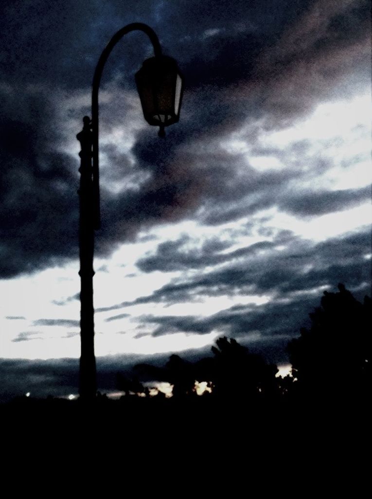 sky, silhouette, cloud - sky, low angle view, street light, cloudy, lighting equipment, dusk, cloud, weather, tree, electricity, dark, nature, tranquility, overcast, pole, no people, outdoors, power line