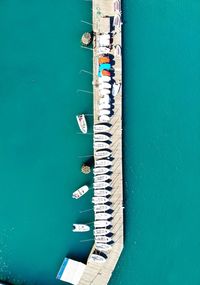 Aerial view of boats moored at jetty in sea on sunny day