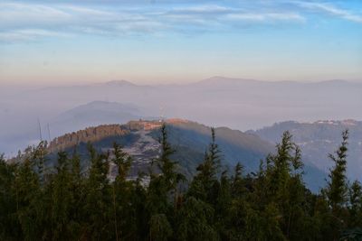 Scenic view of mountains against sky at sunset