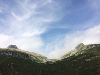 Scenic view of mountains against cloudy sky