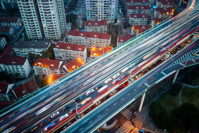 High angle view of illuminated city street and buildings at night