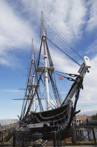 Low angle view of cranes against sky