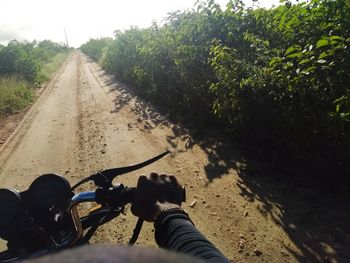 Shadow of man with bicycle on road