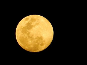 Low angle view of moon against clear sky at night