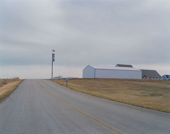 Road by street against sky in city