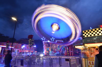 Illuminated ferris wheel at night