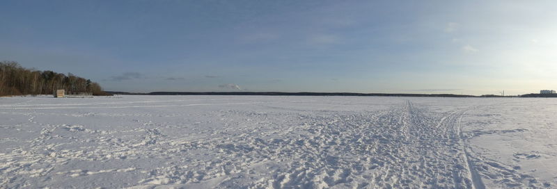 Scenic view of snow covered field against sky