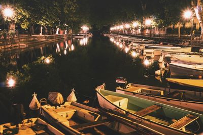 Illuminated bridge over river at night