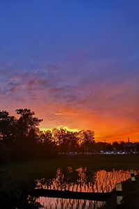 Scenic view of lake against orange sky