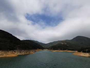 Scenic view of river amidst mountains against sky