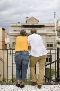 Rear view of senior couple standing on terrace