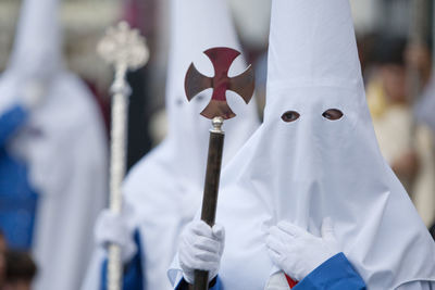 People wearing traditional clothing in city during parade