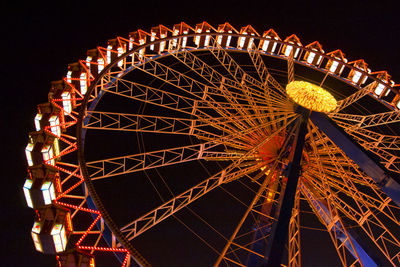 Low angle view of illuminated ferris wheel at night