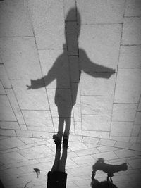 Shadow of man standing on wall