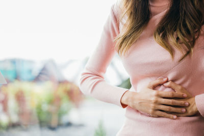 Midsection of woman holding hands