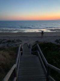 Scenic view of beach against sky during sunset