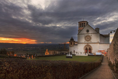 Church in assisi against sky during sunset