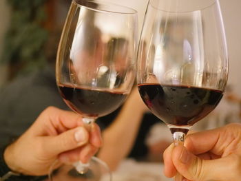Cropped image of hands toasting wineglasses