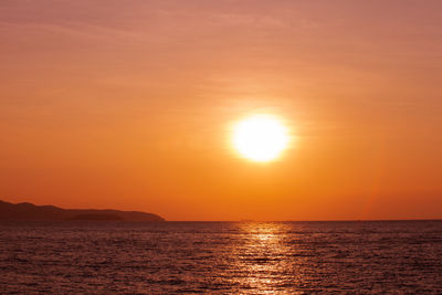 Scenic view of sea against romantic sky at sunset