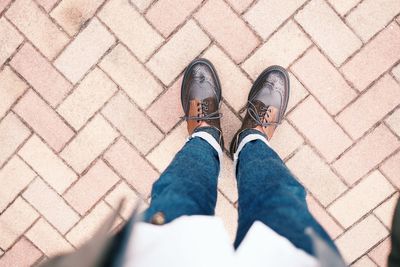 Low section of man standing on footpath