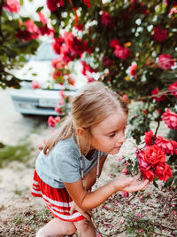 Girl standing by flowering plants