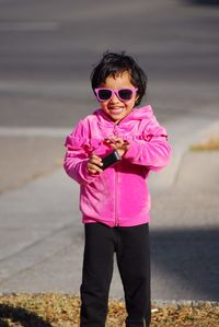 Portrait of girl wearing sunglasses standing outdoors