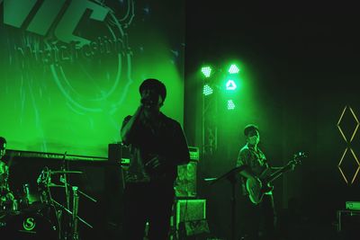 People enjoying music concert at night