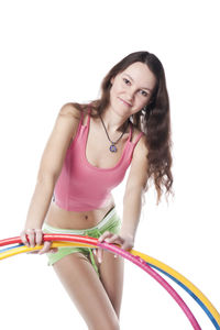 Portrait of a smiling young woman against white background