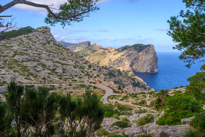 Scenic view of sea and mountains against sky