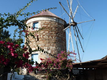 Low angle view of traditional windmill against clear sky
