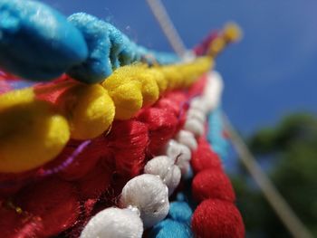 Close-up of multi colored candies against blue sky