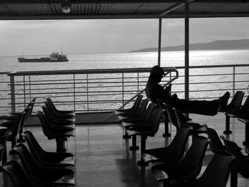 Full length of silhouette man on ferry on sea