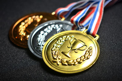 Close-up of medals on black table