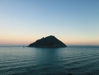 Scenic view of sea against clear sky at sunset