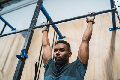 Midsection of man with arms raised