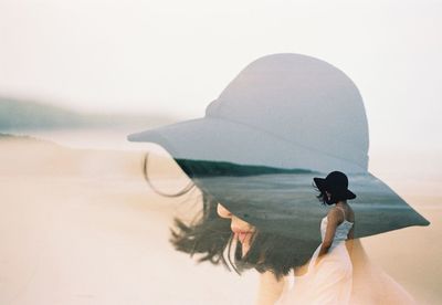 Double exposure of woman at beach