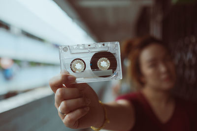 Woman holding audio cassette