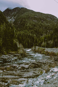 Scenic view of waterfall against sky