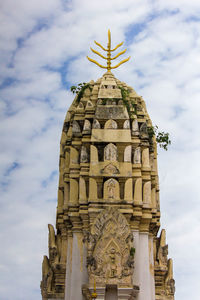 Low angle view of statue of building against cloudy sky