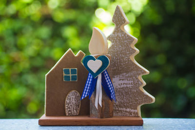 Close-up of stuffed toy on table against trees