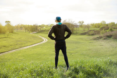 Rear view of man standing on field