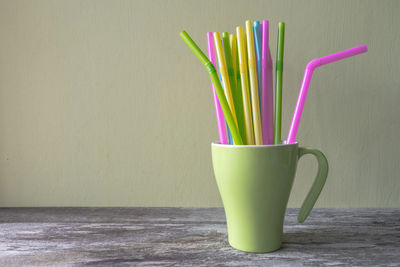 Close-up of drink on table against wall