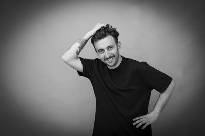 Portrait of smiling young man against white background