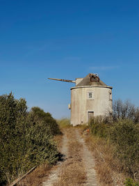 Low angle view of old building against clear blue sky