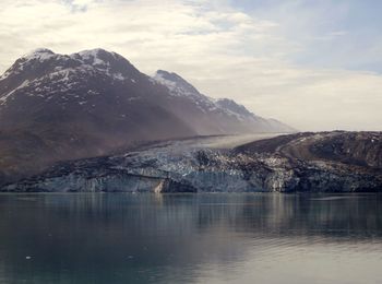Scenic view of lake and snowcapped mountains against sky